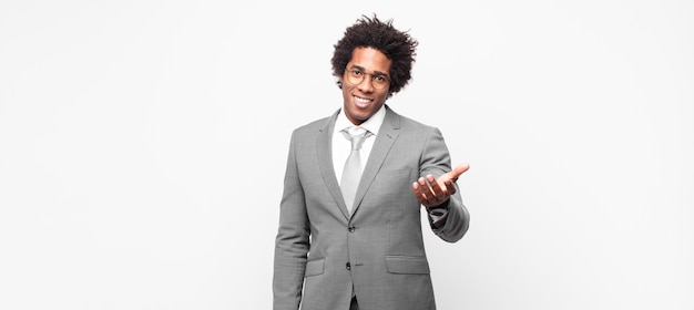 Black afro businessmansmiling, looking happy, confident and friendly, offering a handshake to close a deal, cooperating