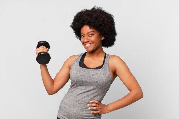 Black afro fitness woman with a dumbbell