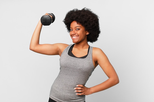 Black afro fitness woman with a dumbbell