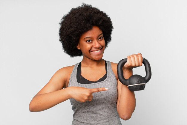 Black afro fitness woman with a dumbbell