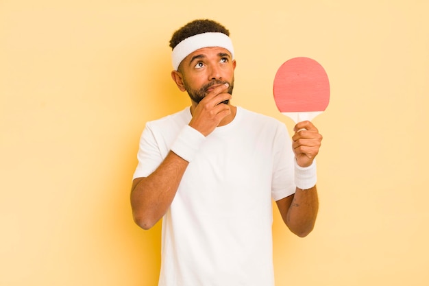 Black afro man thinking feeling doubtful and confused pingpong concept