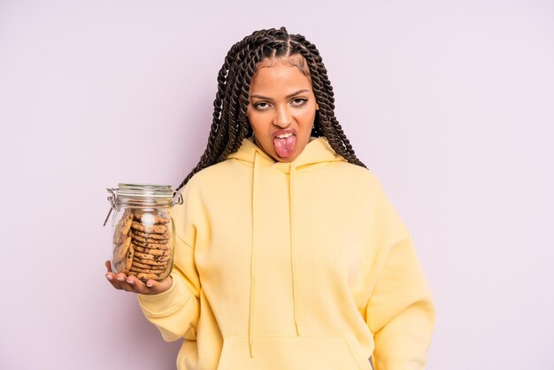 Black afro woman feeling disgusted and irritated and tongue out cookies concept