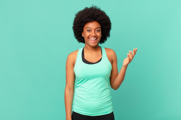 black afro woman feeling happy, surprised and cheerful, smiling with positive attitude, realizing a solution or idea