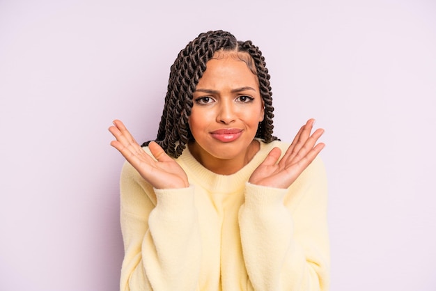 Black afro woman feeling puzzled and confused and doubting