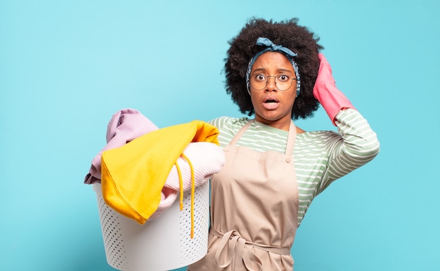 Black afro woman feeling stressed, worried, anxious or scared, with hands on head, panicking at mistake. housekeeping concept.. household concept