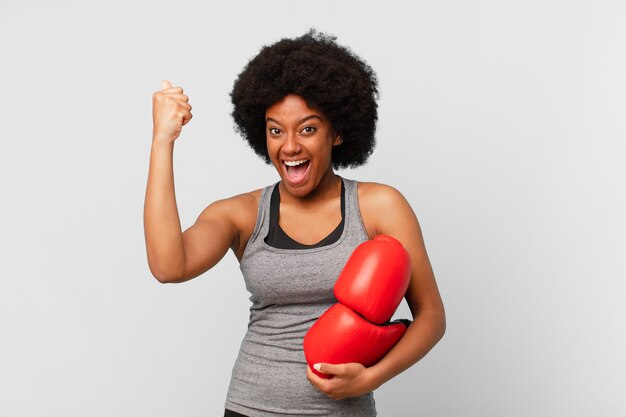 Black afro woman with boxing gloves.