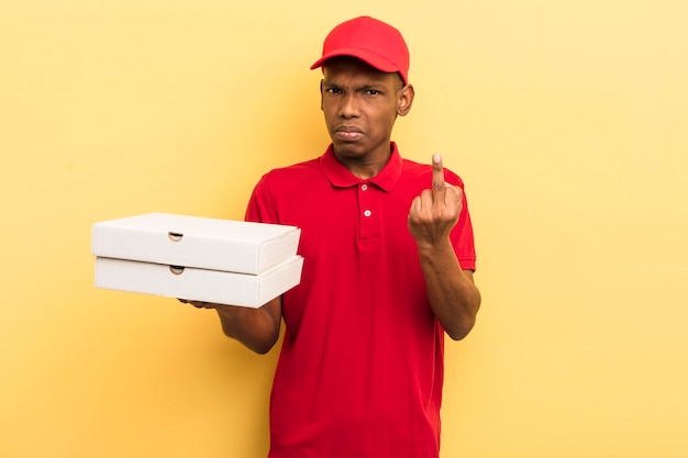 Black afro young man feeling angry annoyed rebellious and aggressive pizza delivery man concept