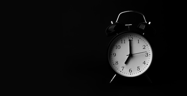 black alarm clock on black background