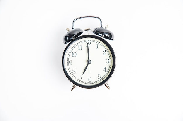 Black alarm clock isolated on white