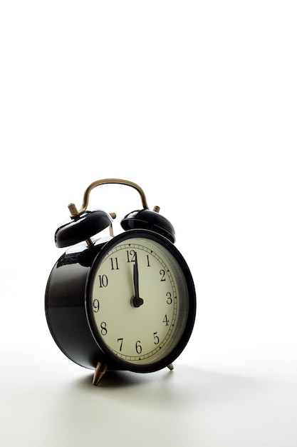 Black alarm clock retro style on white background