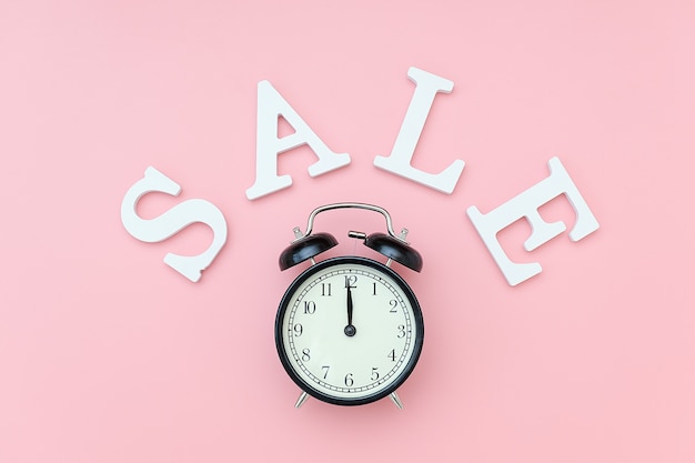 black alarm clock and sale text