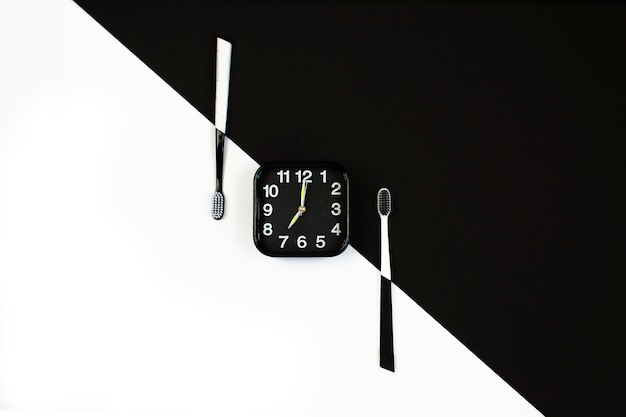 Black alarm clock with manual toothbrush set