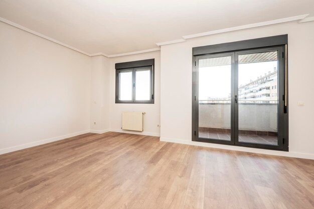 Black aluminum bay window into a living room from a ground floor patio