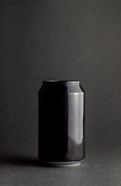 Photo black aluminum can on a black background. mock-up.