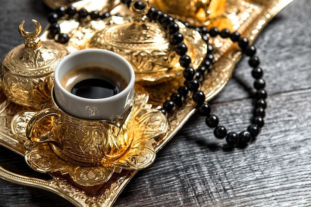 Black arabic coffee, golden decorations and rosary. Ramadan kareem