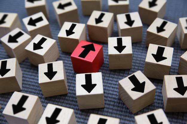 Black arrow on wooden blocks for change .