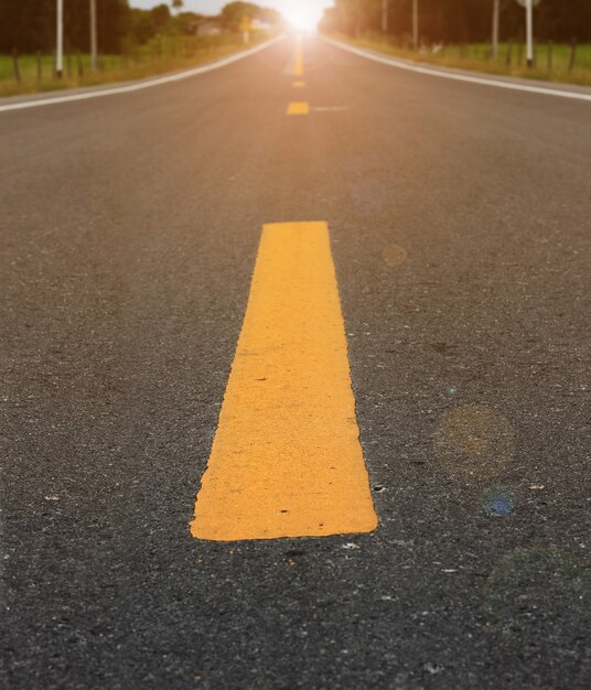 black asphalt road transport with sunset