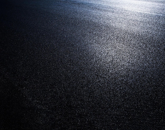 A black asphalt surface with a light on it