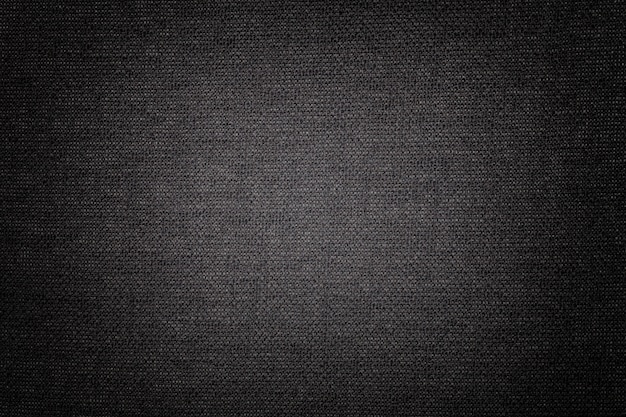 Photo black background from a textile material, fabric with natural texture, backdrop,
