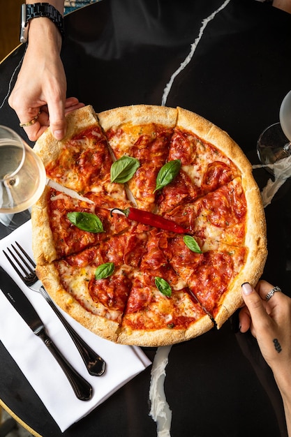 Black background and pizza tasty pepperoni pizza and cooking\
tasty traditional italian pizza