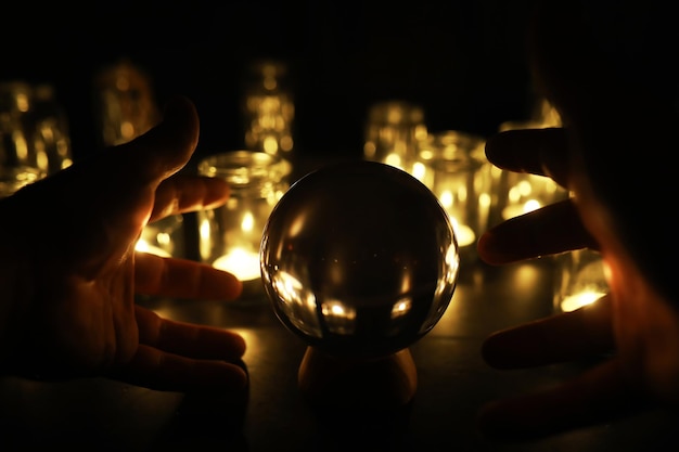 Black background with a ball and candles Divination and prediction of fate