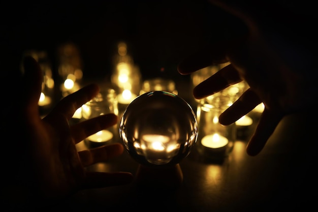 Black background with a ball and candles Divination and prediction of fate