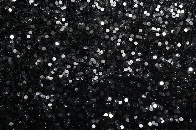 a black background with silver glitter and silver glitter on it.