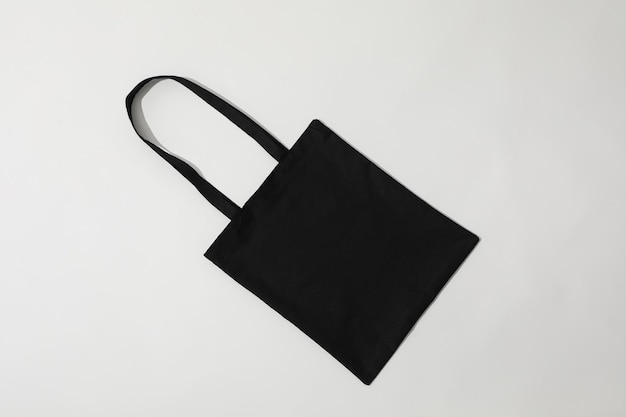 Photo a black bag lies on a white background