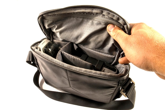 Black bag with drone and hand isolated on white