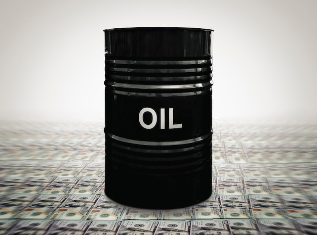 A black barrel with the inscription oil is worth dollars The concept of earning money on the sale of oil Oil drums on US dollars background