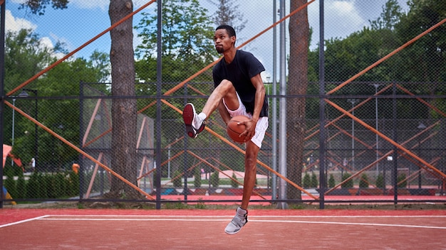 Black basketball player playing in the field