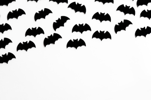 Black bat shapes on a white background Halloween background