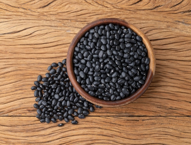 Black beans in a bowl over wooden table