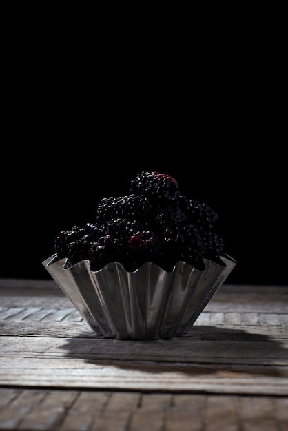 Black berry on a black background in a rustic style