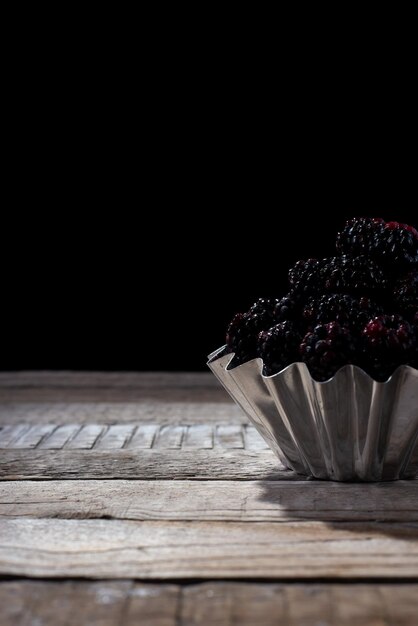 Black berry on a black background in a rustic style