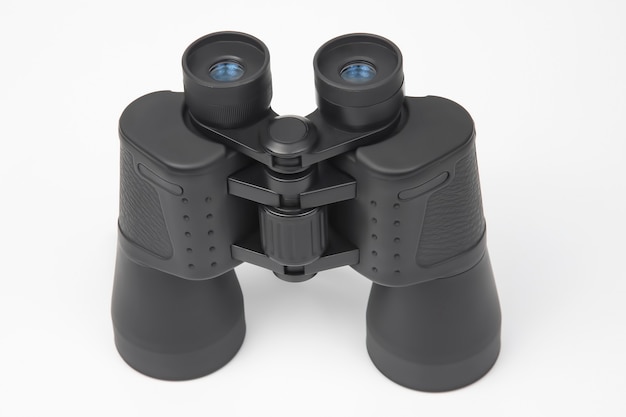 Black binoculars on a white. optical instrument
