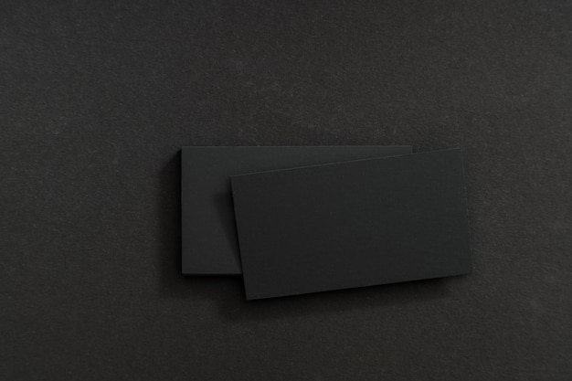 Black, blank business cards on a black table