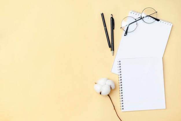 Photo black blank notebook pen glasses goggles top view on beige background top view desk arrangement time management planning concept minimal style mock up with copy space template logo design