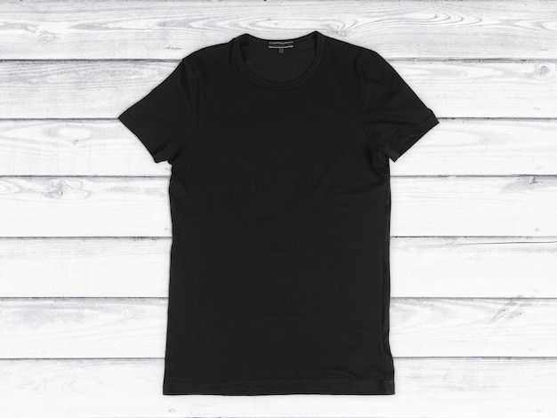 Photo black blank tshirt on a white wooden background