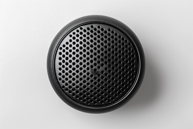 Black Bluetooth speaker on white background top view with metal grille