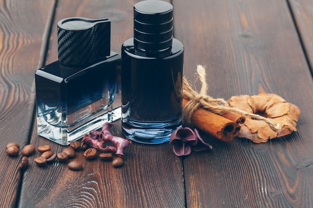 Black bottle of perfume placed on a wooden table