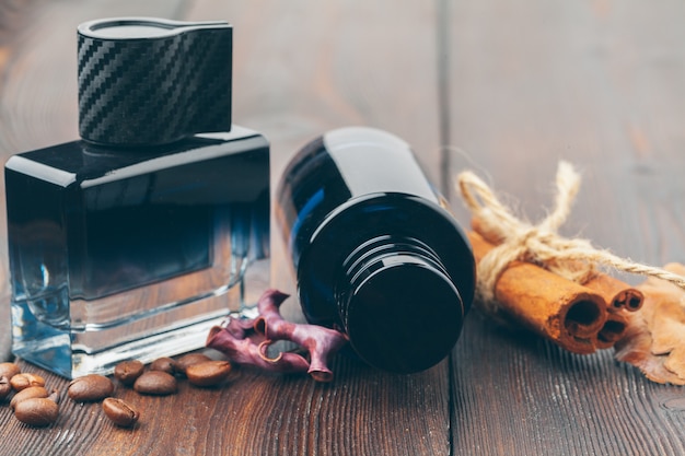 Black bottle of perfume placed on a wooden table 