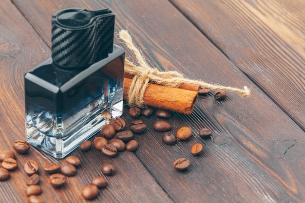 Black bottle of perfume placed on a wooden table 