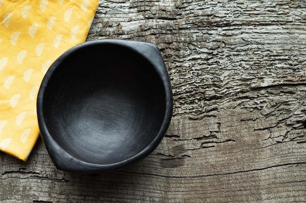 Black bowl on a rustic wooden background Copy space