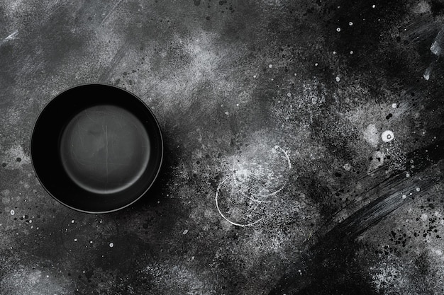 Black bowl set, with copy space for text or food, with copy space for text or food, top view flat lay, on black dark stone table background