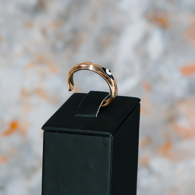 A black box with a gold ring on it