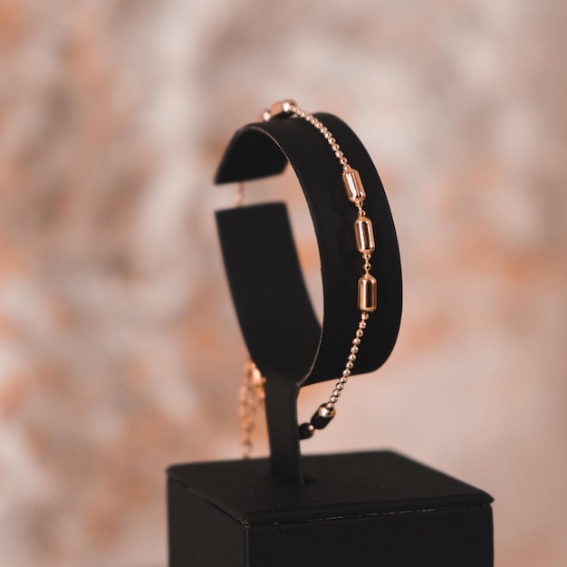 A black bracelet with gold rings on it