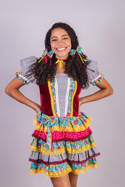 Black Brazilian woman wearing June party clothes fraternization in the name of Sao Joao camp Portrait