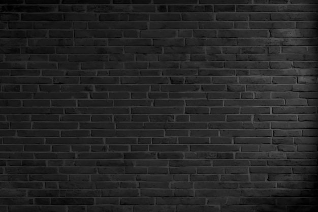 Black brick wall background with a light on it