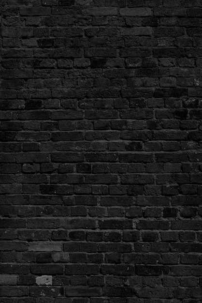 Black brick wall. Loft interior design. Black paint of the facade.